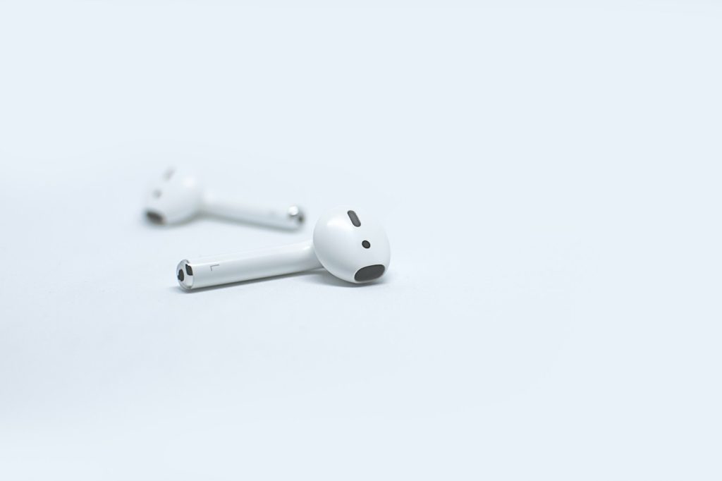 Apple AirPods on white surface