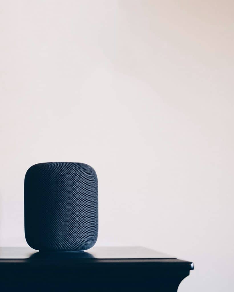 black Apple HomePod speaker on table