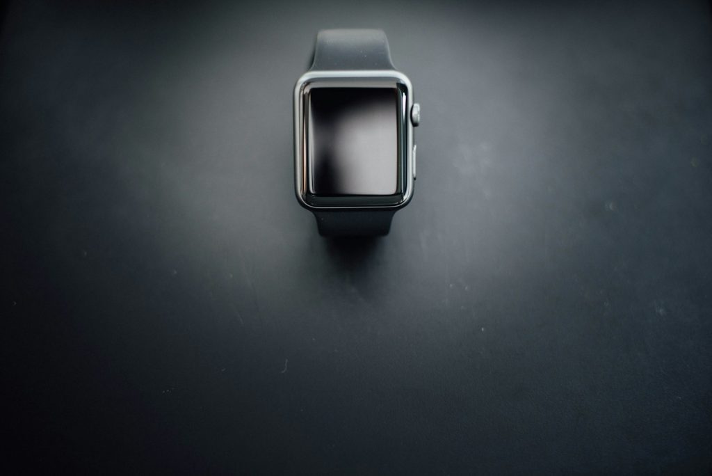 shallow focus photography of silver Apple Watch with black Sport Band